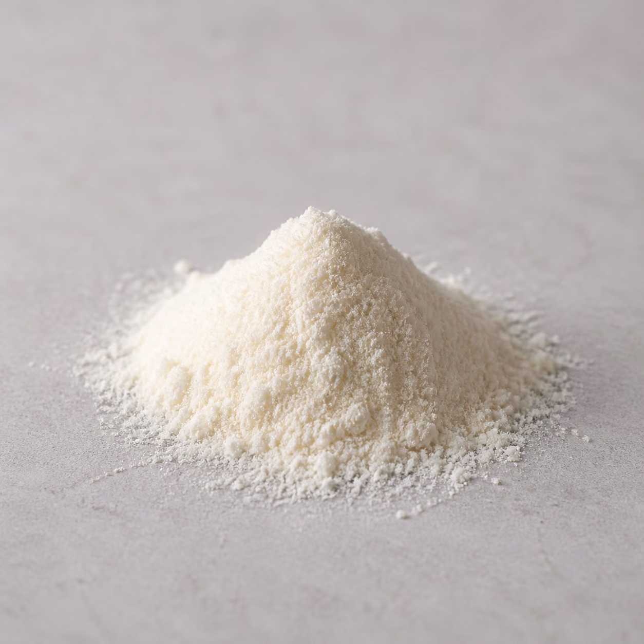 Fine hydrolyzed whey protein powder on a neutral stone surface